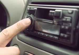 Finger turning dial on car radio