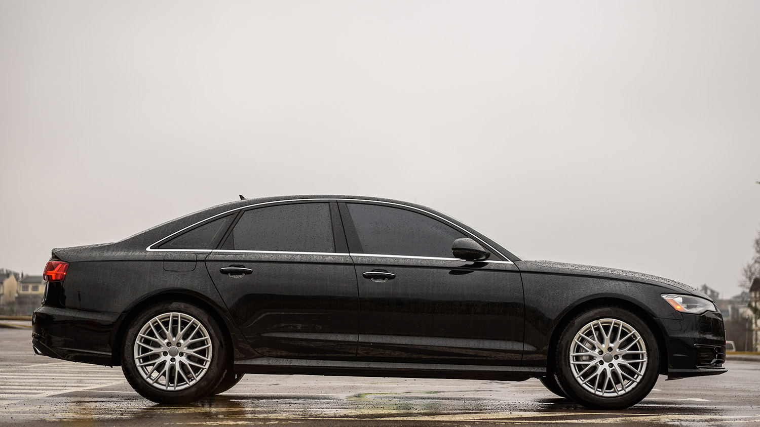 Black car with tinted windows in the rain