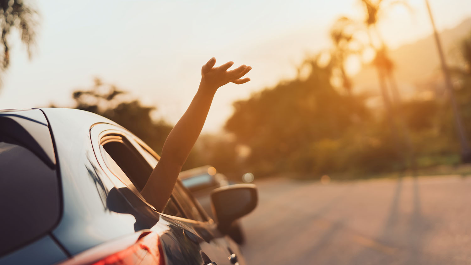 Hatchback Car travel driving family road trip for summer vacation in blue car at sunset