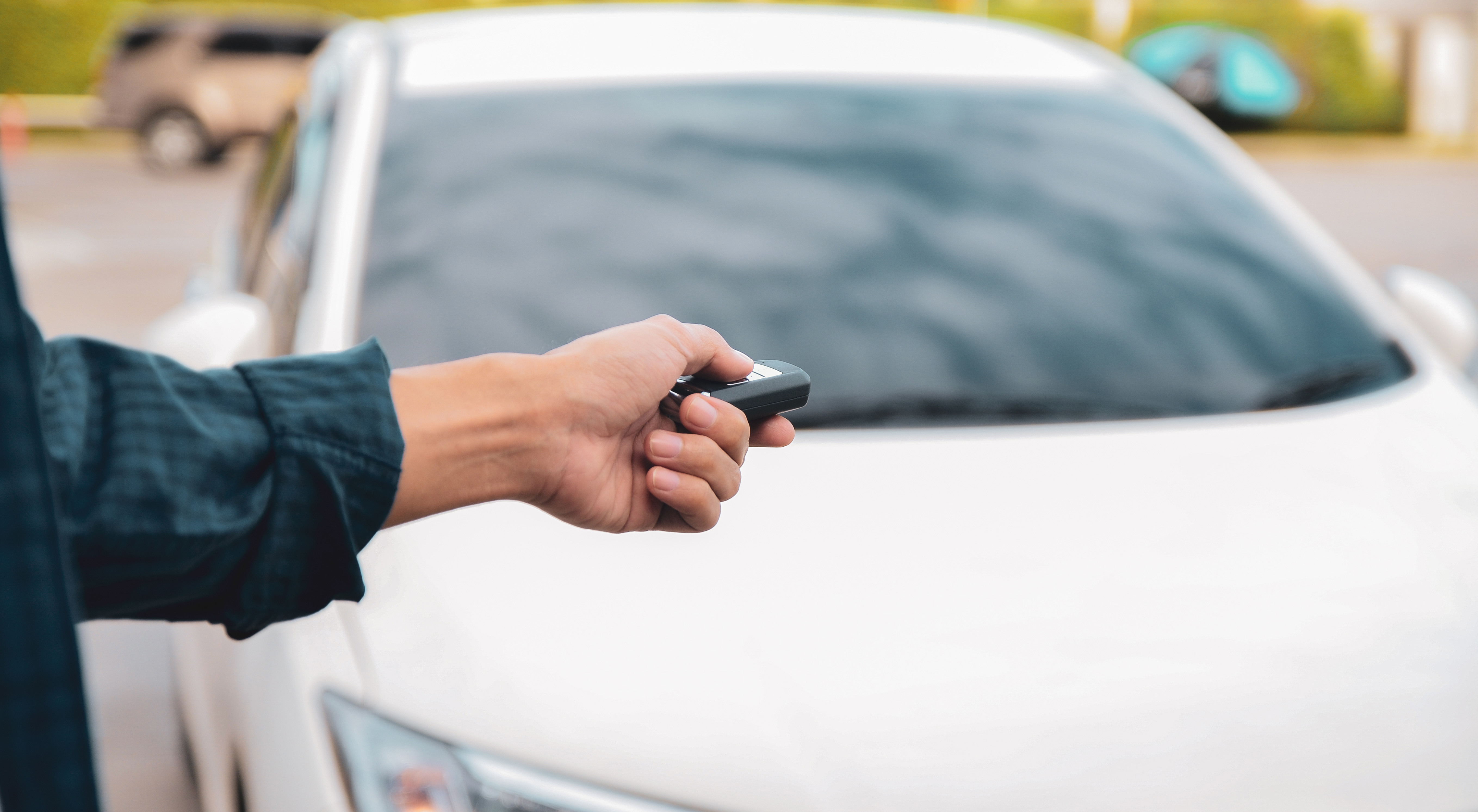 Man starting his white car with a car starter 