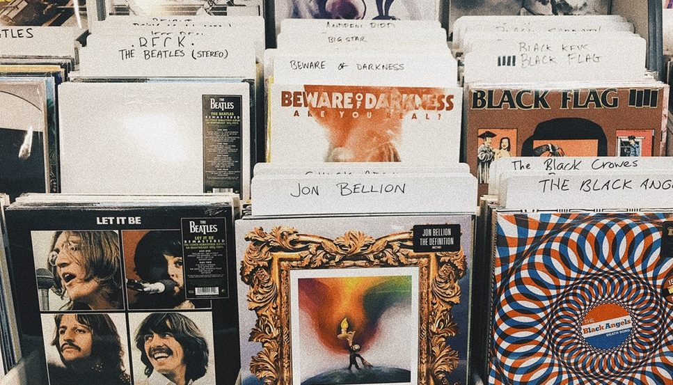 A selection of CDs available at a music store, including the Beatles, Jon Bellion, and more.