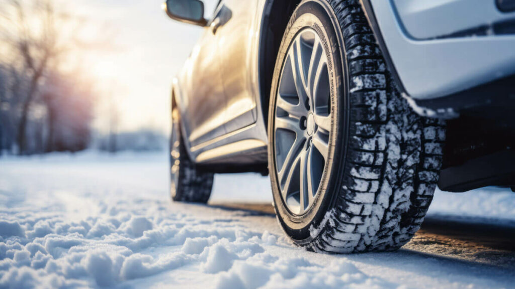 Car driving down a snowy road